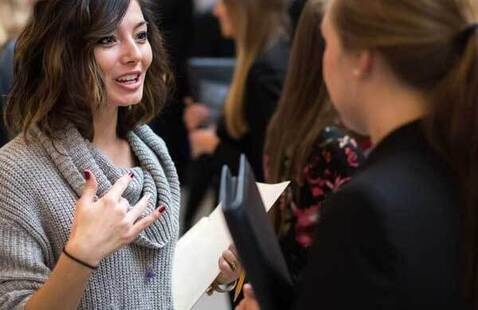 student talking with recruiter