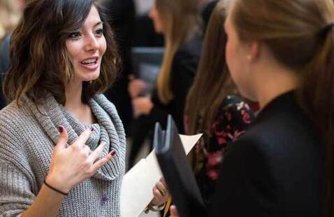 student talking with recruiter