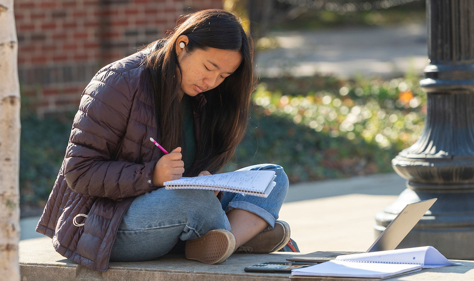 A photo of a student studying a notebook
