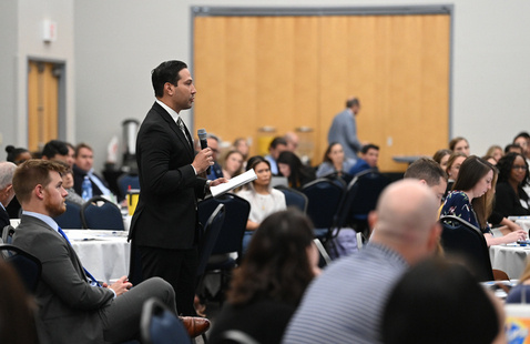Audience member talking at a conference
