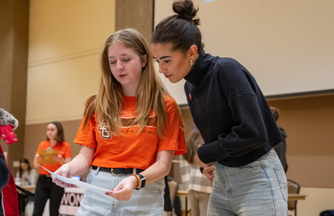 2 students looking at a table