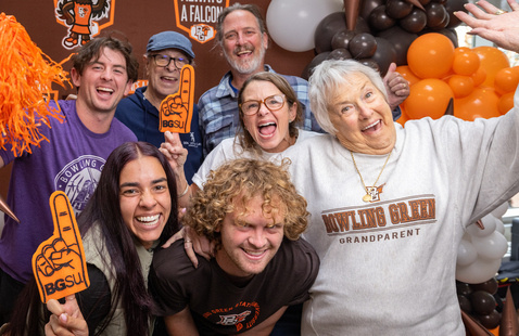 Loved ones with their student at family weekend