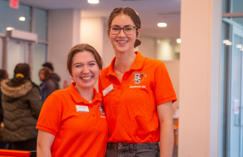 Two Resident Advisors (RA's), welcome new students moving into their hall. 
