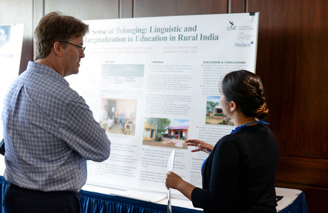 Student giving a poster presentation 
