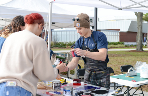 Students at an interactive painting table