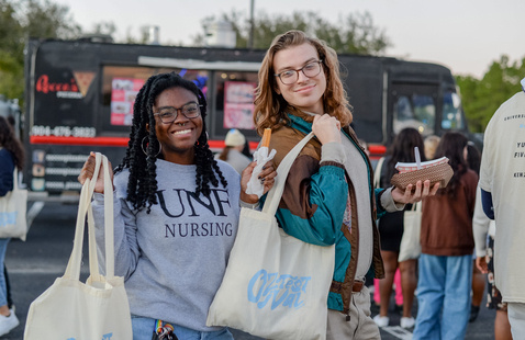 Two students with UNF swag bags 