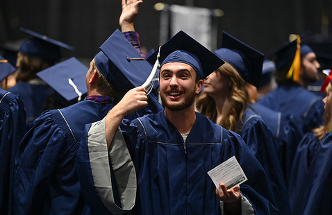 Student going to move his tassel on his cap during graduation