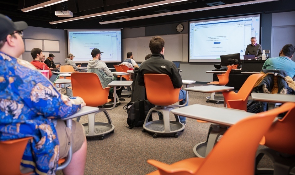 Professor teaching students in a classroom.