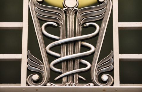Decorative element in Fitzsimons Building depicting the caduceus, two snakes winding around a winged staff