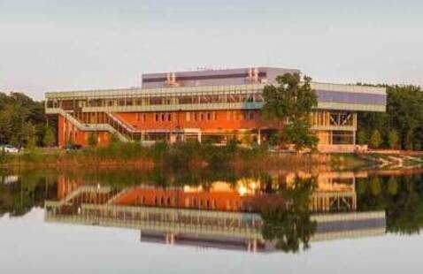 Appears to be an image of the Lee Center overlooking the lake at Oakton College's Des Plaines campus.
