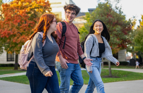 students walking outside and smiling