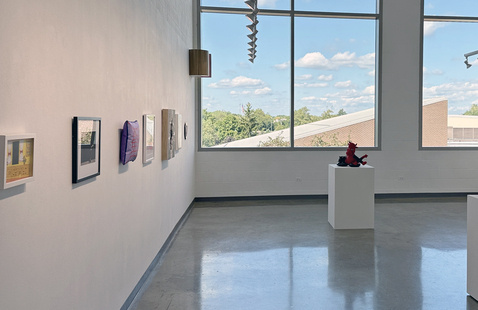 Paintings, photographs and sculpture are on display in the gallery.