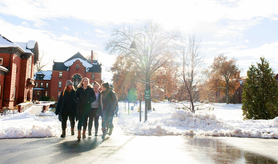 Students walk across a snowy Mount Holyoke campus.