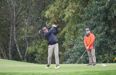 A family play a round of golf during the family weekend golf tournament.