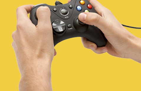 Closeup on a pair of hands holding a generic video game controller