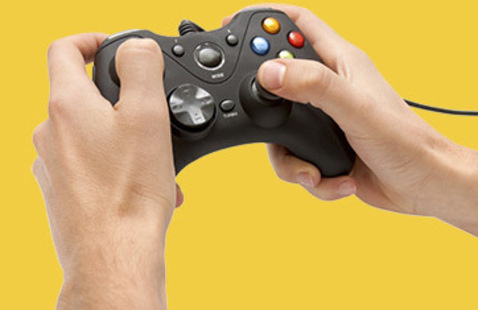 Closeup on a pair of hands holding a generic video game controller