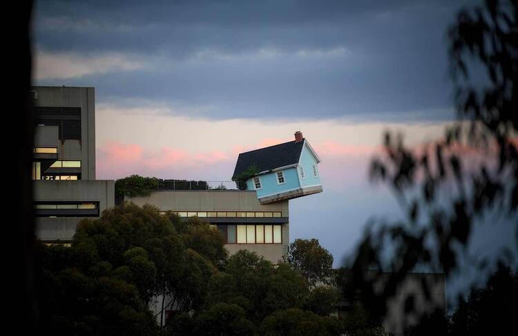 House hanging off the top corner of a building