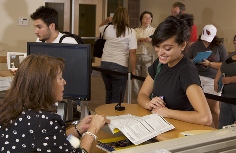 Student speaks to registration office staff member