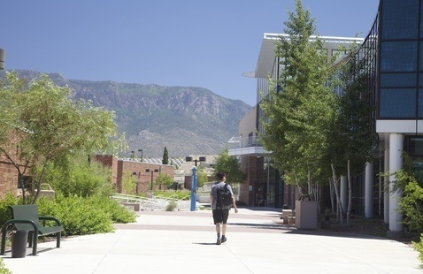 Student walks through Montoya campus in summer