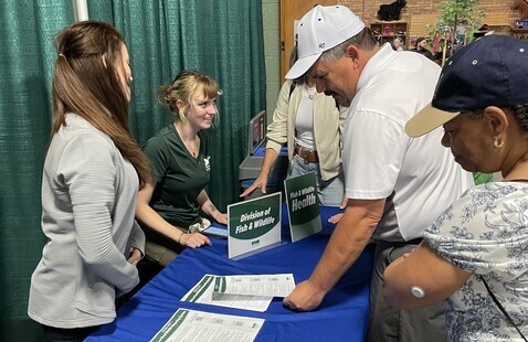 People talking to each other at a booth