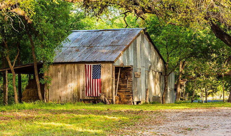 a wooden barn with an American flag on the side