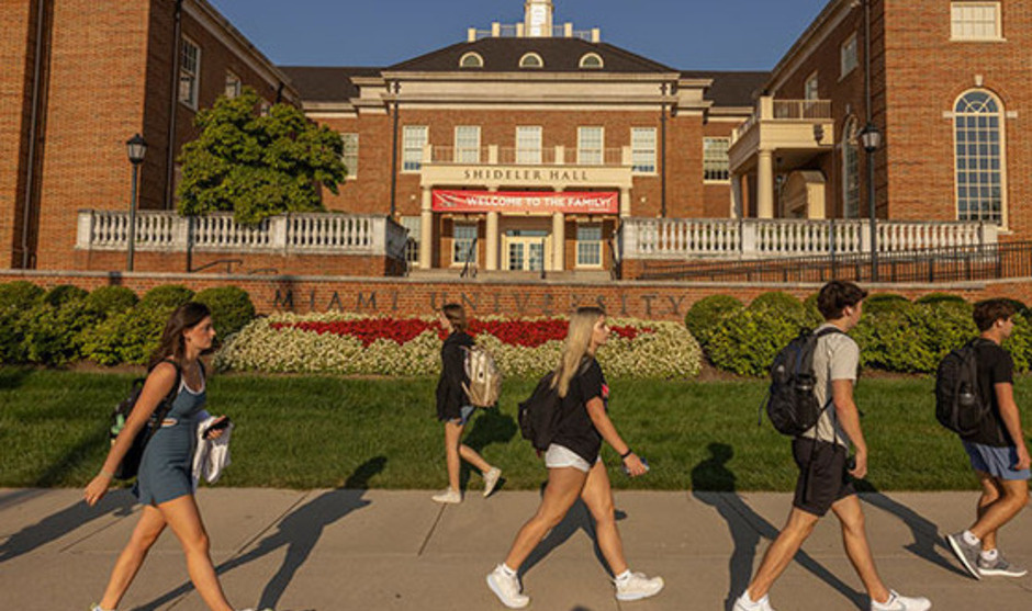 students walk in front of shideler hall