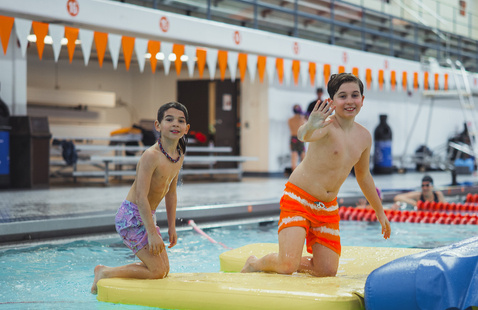 Two people on a pool inflatable