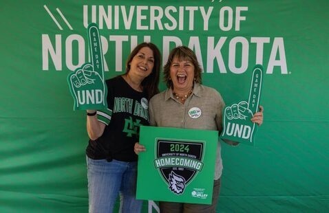 Alums holding foam fingers