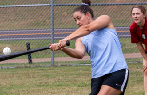 Person swinging a wiffleball bat