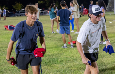 Students playing cornhole