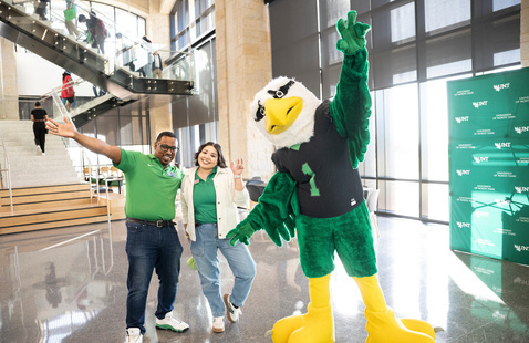 Photo of Scrappy the Eagle with UNT staff members.