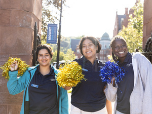Orientation leaders smile posing with pompoms at the Gates, Orientation 2023.