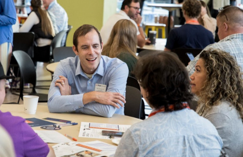 An Admissions representative talks with a prospective family.