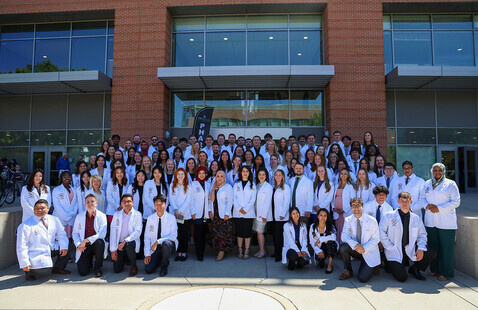 Students celebrating at white coat ceremony 