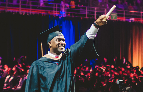 Student getting his diploma at FIU commencement