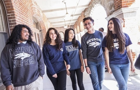 Group of students walking and talking on campus
