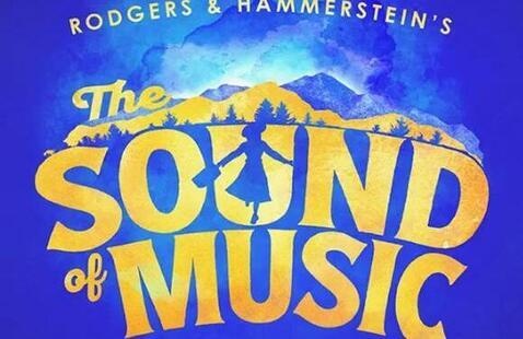Dark blue-purple bacjground as well as mountain tops.  Gold lettering spells out Rodgers & Hammerstein's across the top, and larger gold letters spelling out The Sound of Music.
