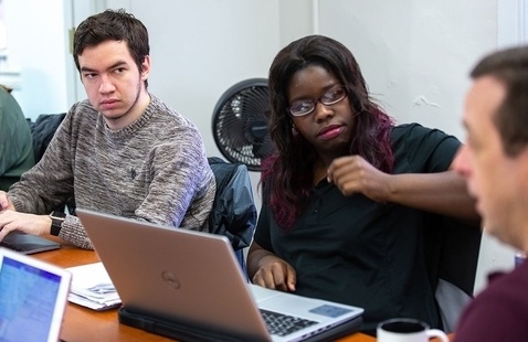 two students in a classroom discussion