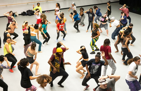 Full dance class with students in mid-movement at Harvard Dance Center