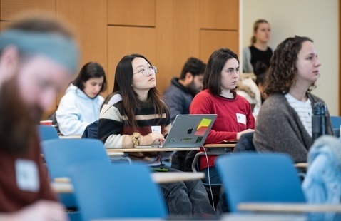 Students listening to a speaker in a lecture hall