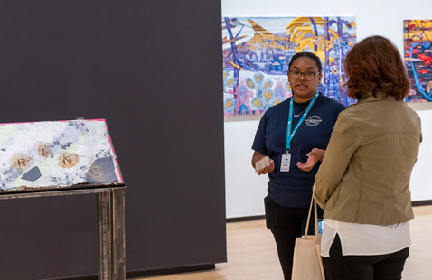 Two people looking at art in a museum.