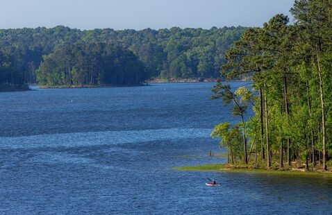 A person in a boat within Jordan Lake.