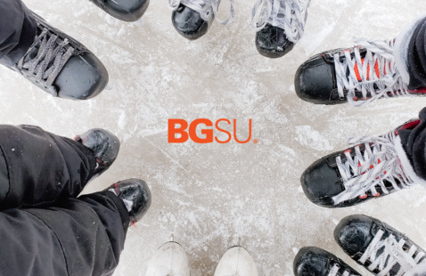 a grouping of ice skates on a rink with bgsu logo i the middle