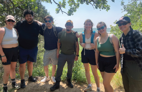 Hikers standing front of a natural vista.