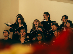 MHC students singing together, holding song books.