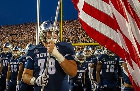 University of Nevada, Reno football player holding the American flag