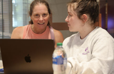 student and parent working on laptop