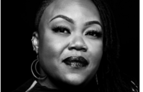 close up photo of person looking at camera, black and white photo. 