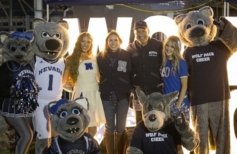 President Sandoval and Lauralyn with mascots and cheer at tailgate