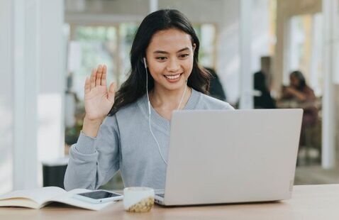 Young woman raising her hand